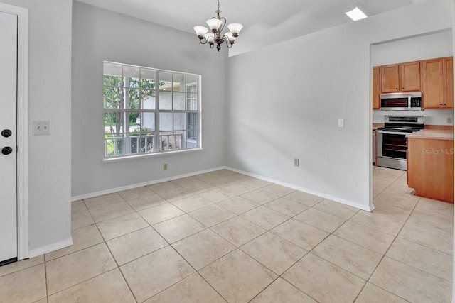 unfurnished dining area featuring a chandelier and light tile patterned floors