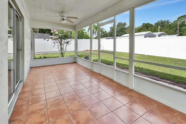 unfurnished sunroom with ceiling fan