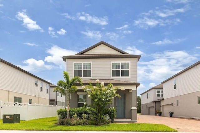 view of front of home with a garage and a front lawn