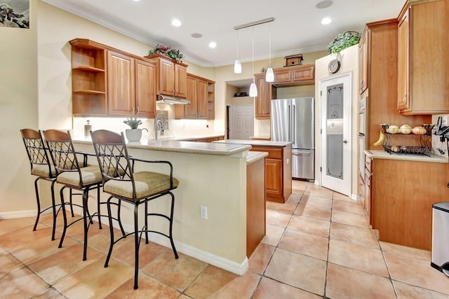 kitchen with ornamental molding, stainless steel refrigerator, kitchen peninsula, and light tile floors