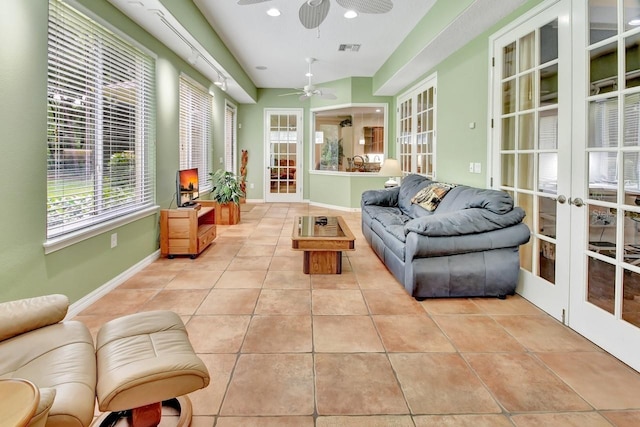 sunroom featuring plenty of natural light, ceiling fan, and french doors