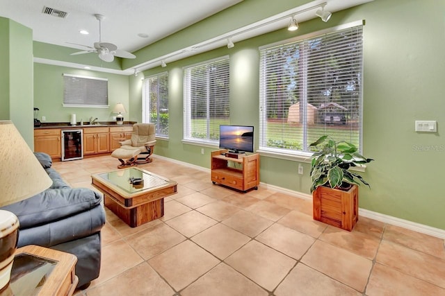 living room featuring beverage cooler, sink, track lighting, ceiling fan, and light tile floors