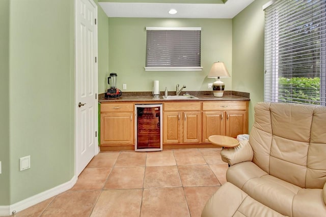 interior space featuring light tile floors, plenty of natural light, and beverage cooler