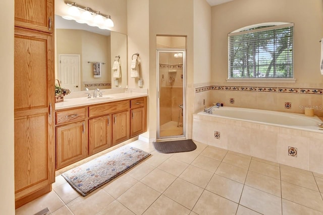 bathroom featuring tile flooring, shower with separate bathtub, and vanity