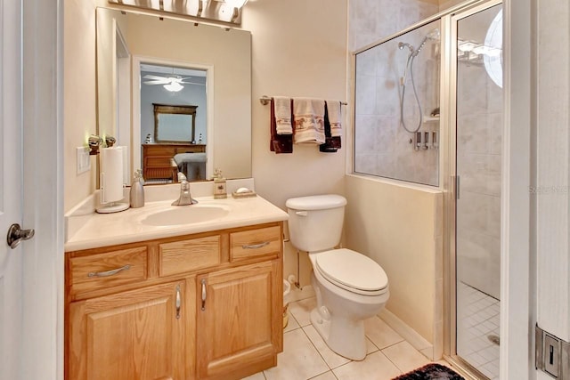 bathroom featuring tile flooring, a shower with shower door, oversized vanity, and toilet