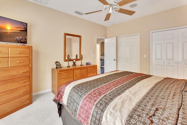 carpeted bedroom with multiple closets and ceiling fan