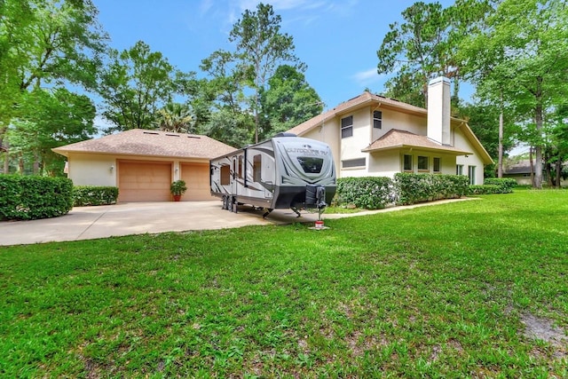 view of front of house featuring a garage and a front lawn