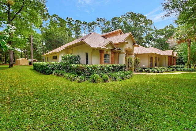 view of side of property with a yard