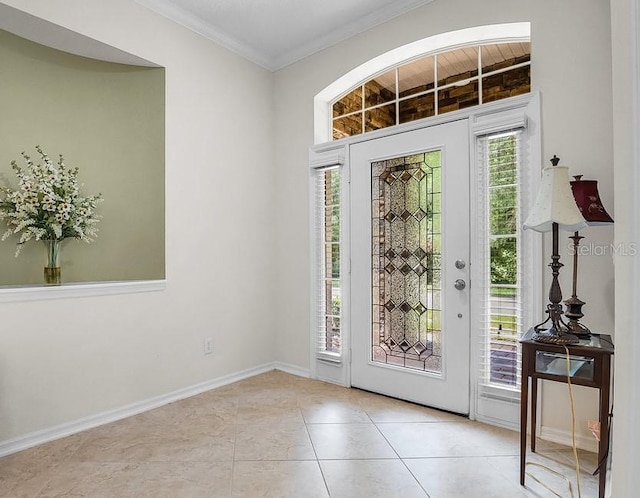 doorway featuring light tile patterned flooring and ornamental molding