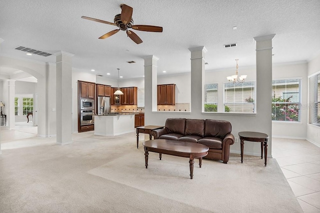 tiled living room with ceiling fan with notable chandelier, ornamental molding, and a textured ceiling