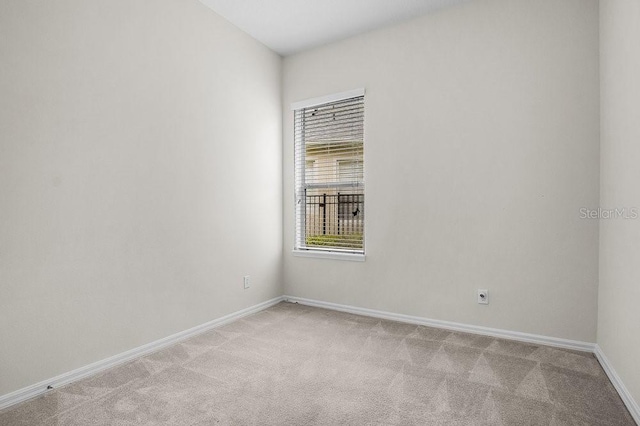 unfurnished room with light colored carpet