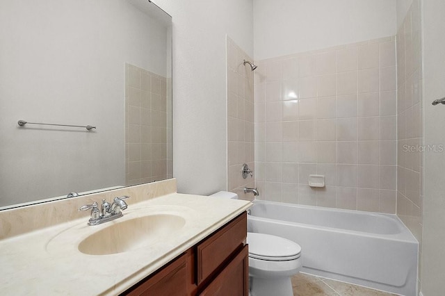 full bathroom featuring tile patterned flooring, vanity, tiled shower / bath combo, and toilet