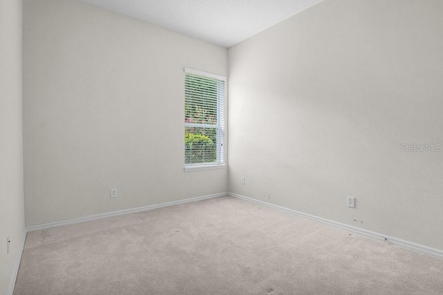 unfurnished room with light carpet