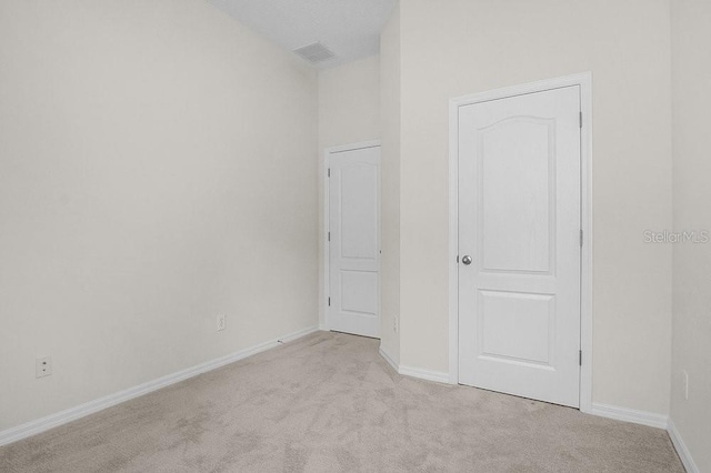 unfurnished room with light carpet