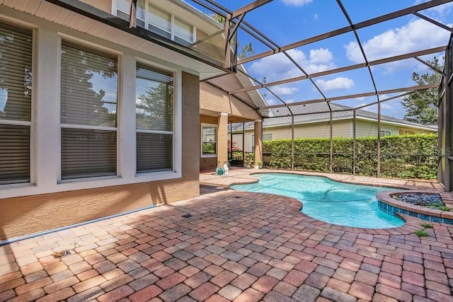 view of pool with a lanai and a patio