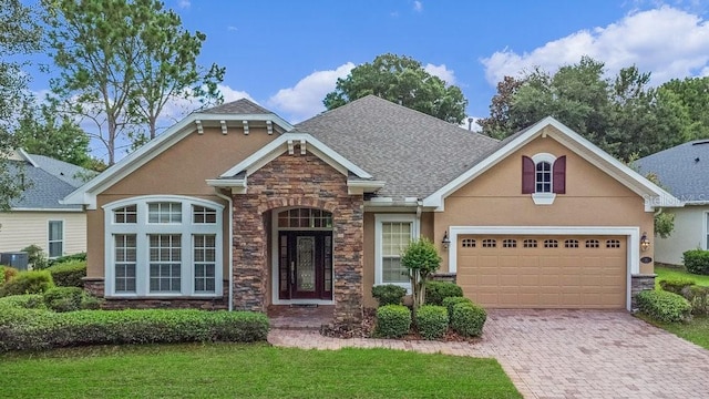 view of front of house with a front lawn and a garage