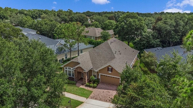 birds eye view of property featuring a view of trees