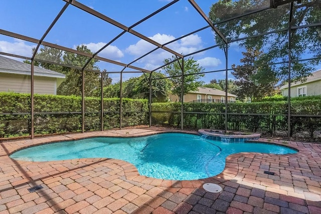 view of pool with a lanai, a pool with connected hot tub, and a patio