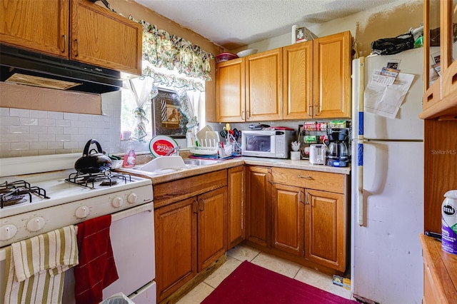 432 Marion St, Daytona Beach, FL 32114 - kitchen with tasteful backsplash, white appliances, a textured ceiling, light tile patterned flooring, and sink
