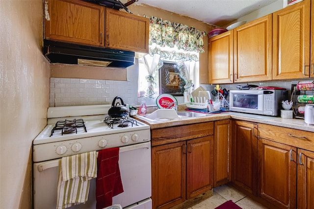 432 Marion St, Daytona Beach, FL 32114 - kitchen featuring sink, white appliances, and tasteful backsplash