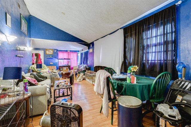 432 Marion St, Daytona Beach, FL 32114 - living room with vaulted ceiling, wood-type flooring, and a textured ceiling