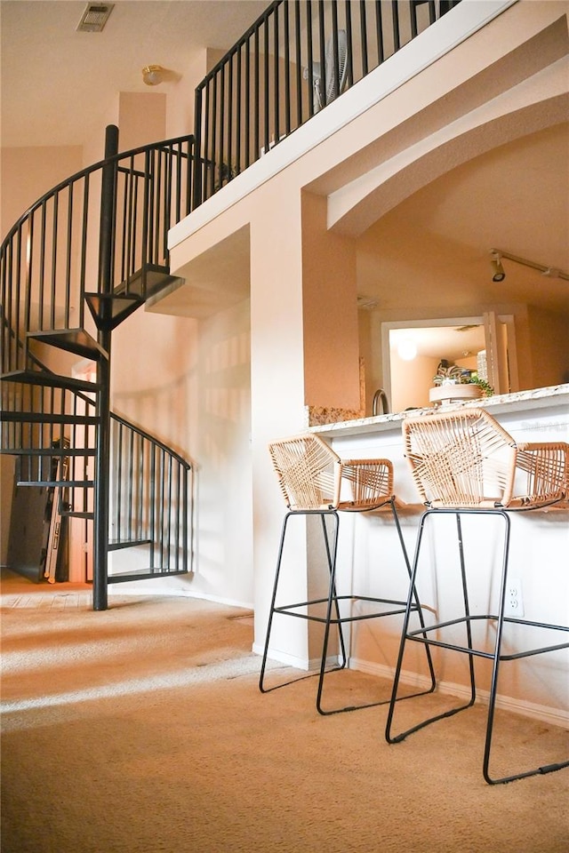 interior space with a high ceiling and carpet flooring