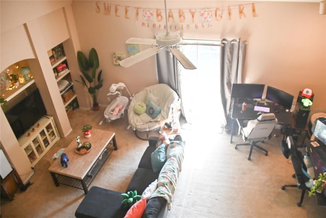 living room with ceiling fan and carpet floors