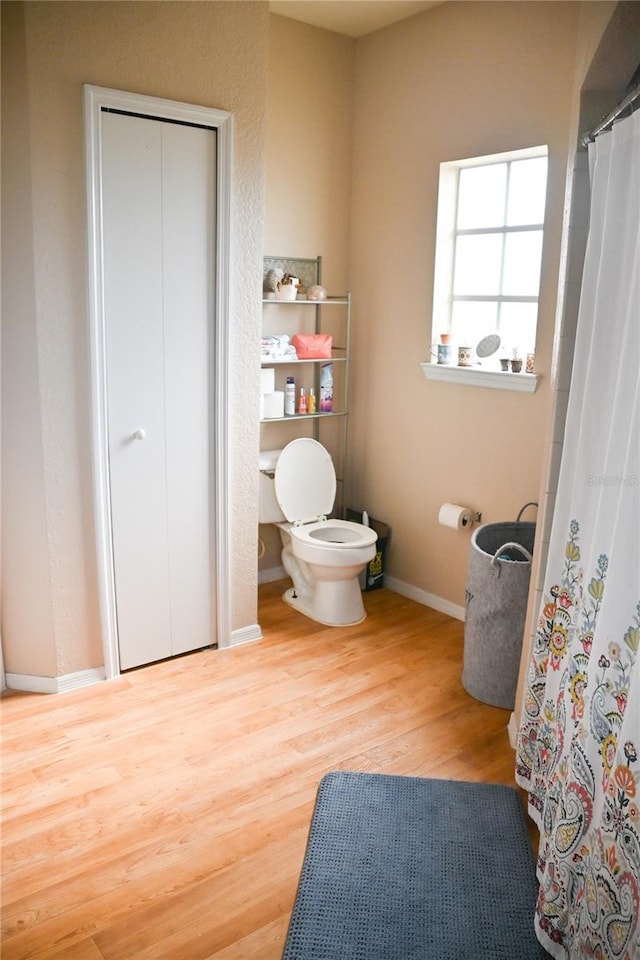 bathroom featuring hardwood / wood-style floors and toilet