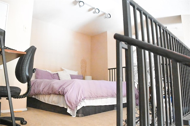 bedroom with carpet flooring and rail lighting