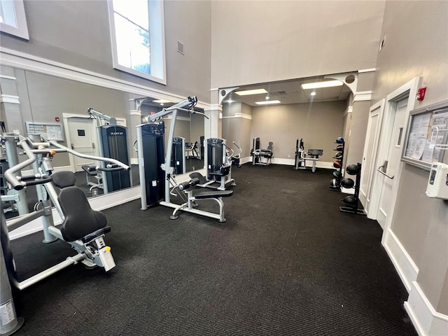 gym featuring a towering ceiling