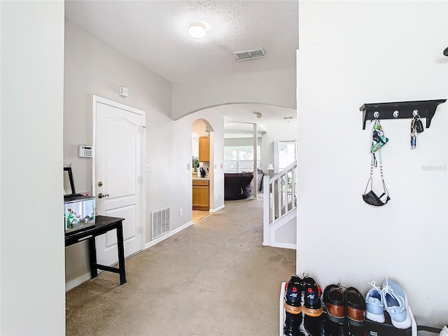 hallway featuring a textured ceiling