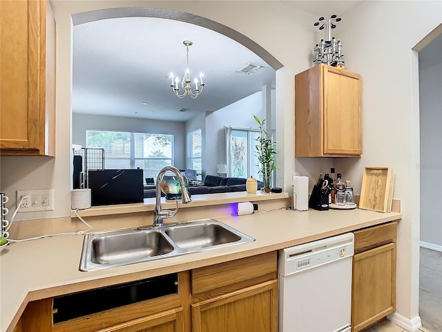 kitchen with light brown cabinetry, white dishwasher, sink, decorative light fixtures, and an inviting chandelier