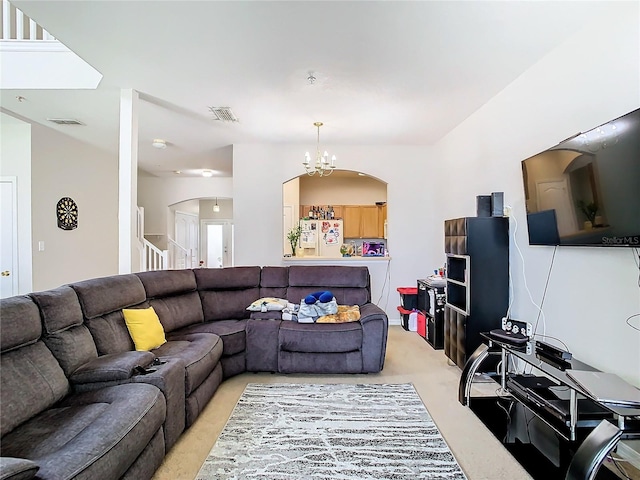 living room featuring light carpet and a notable chandelier