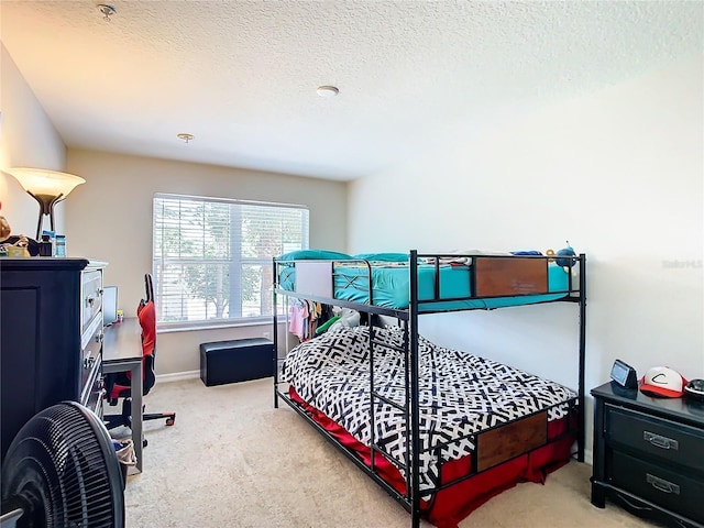 bedroom with carpet floors and a textured ceiling