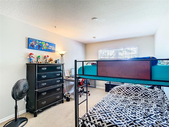 bedroom with a textured ceiling and light colored carpet