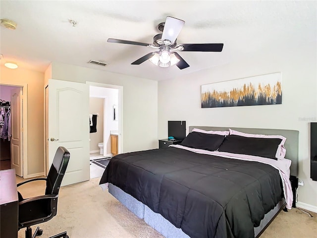 bedroom with ensuite bath and ceiling fan