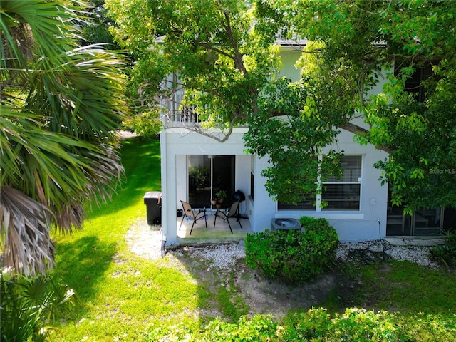 rear view of house with a yard and a patio