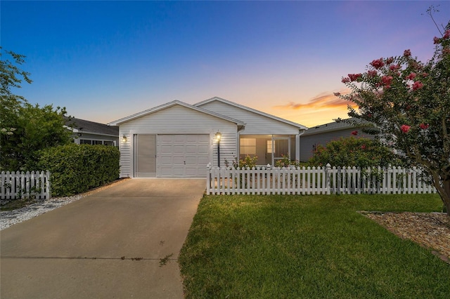 ranch-style house featuring a yard and a garage