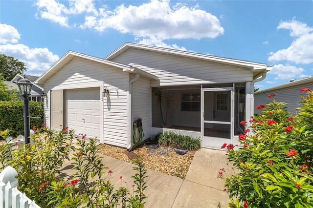 view of front of house featuring a garage and a sunroom