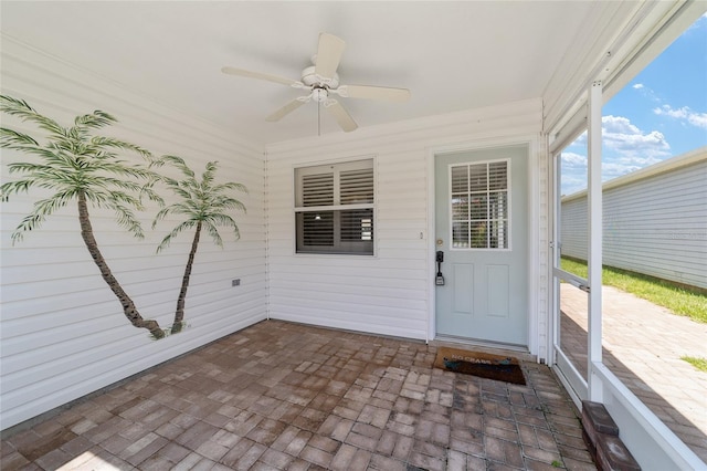 unfurnished sunroom with ceiling fan