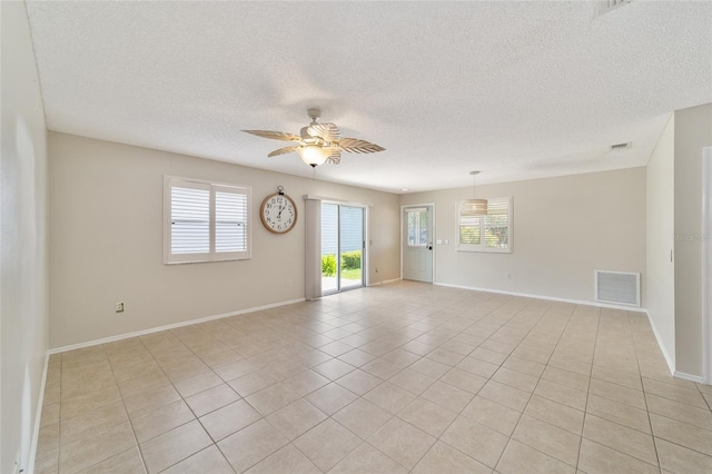 unfurnished room featuring ceiling fan, a healthy amount of sunlight, and light tile patterned floors