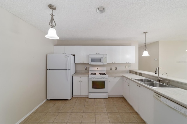 kitchen featuring white cabinetry, sink, pendant lighting, and white appliances