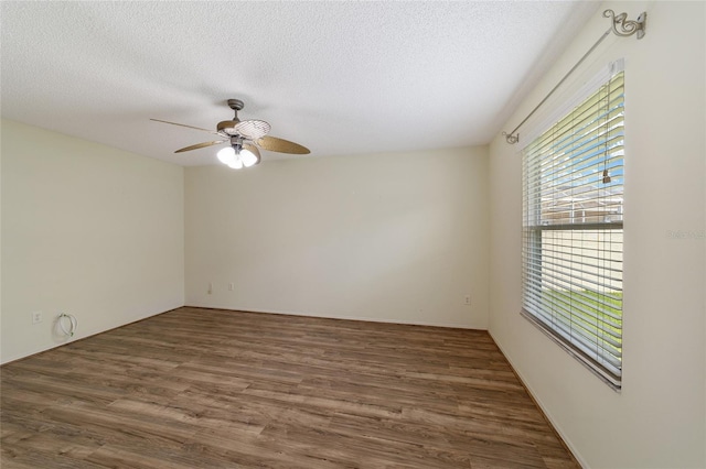 spare room featuring ceiling fan, dark hardwood / wood-style flooring, and a textured ceiling