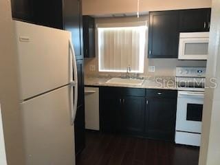 kitchen with sink and white appliances