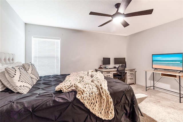 bedroom with ceiling fan and light carpet