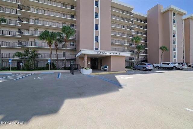 view of building exterior featuring uncovered parking