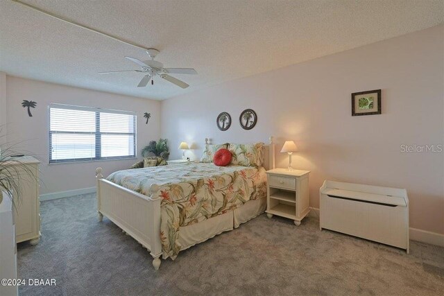 bedroom with a textured ceiling, ceiling fan, and carpet flooring