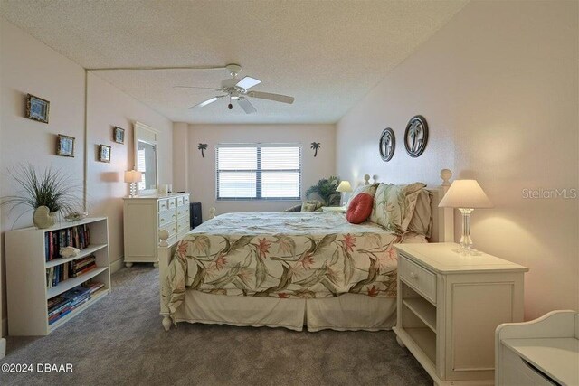 carpeted bedroom with a textured ceiling and ceiling fan