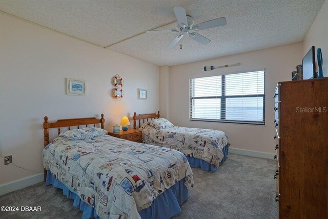 carpeted bedroom featuring a textured ceiling and ceiling fan