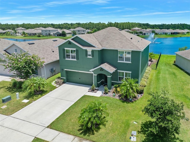 view of front of property with a water view, a garage, and a front yard